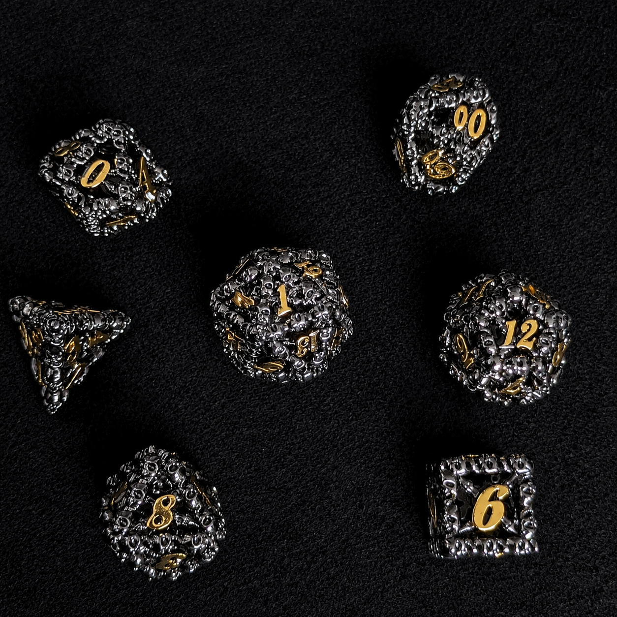 The Ossuary Set — Hollow Skull Metal Dice, Black & Gold