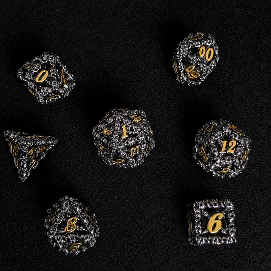 The Ossuary Set — Hollow Skull Metal Dice, Black & Gold
